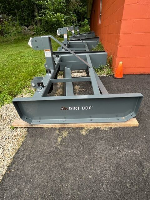 A dirt dog is sitting on the side of the road