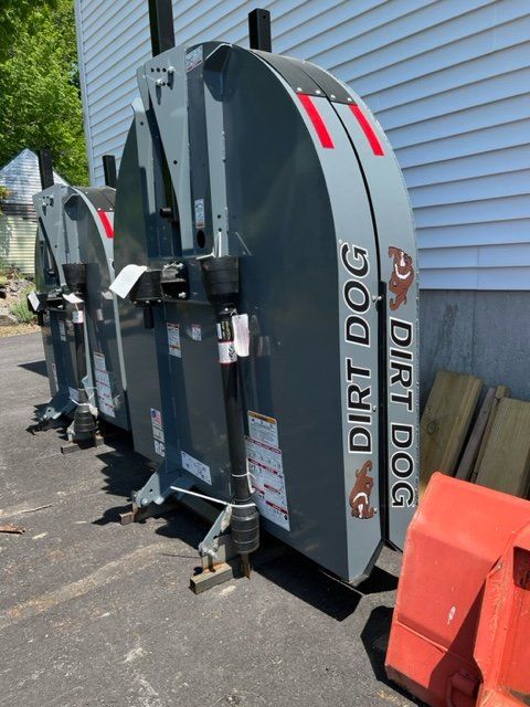 A dirt dog lawn mower is parked in a parking lot