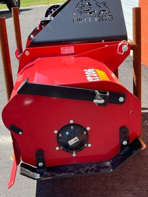 A red bulldog machine is sitting on the ground