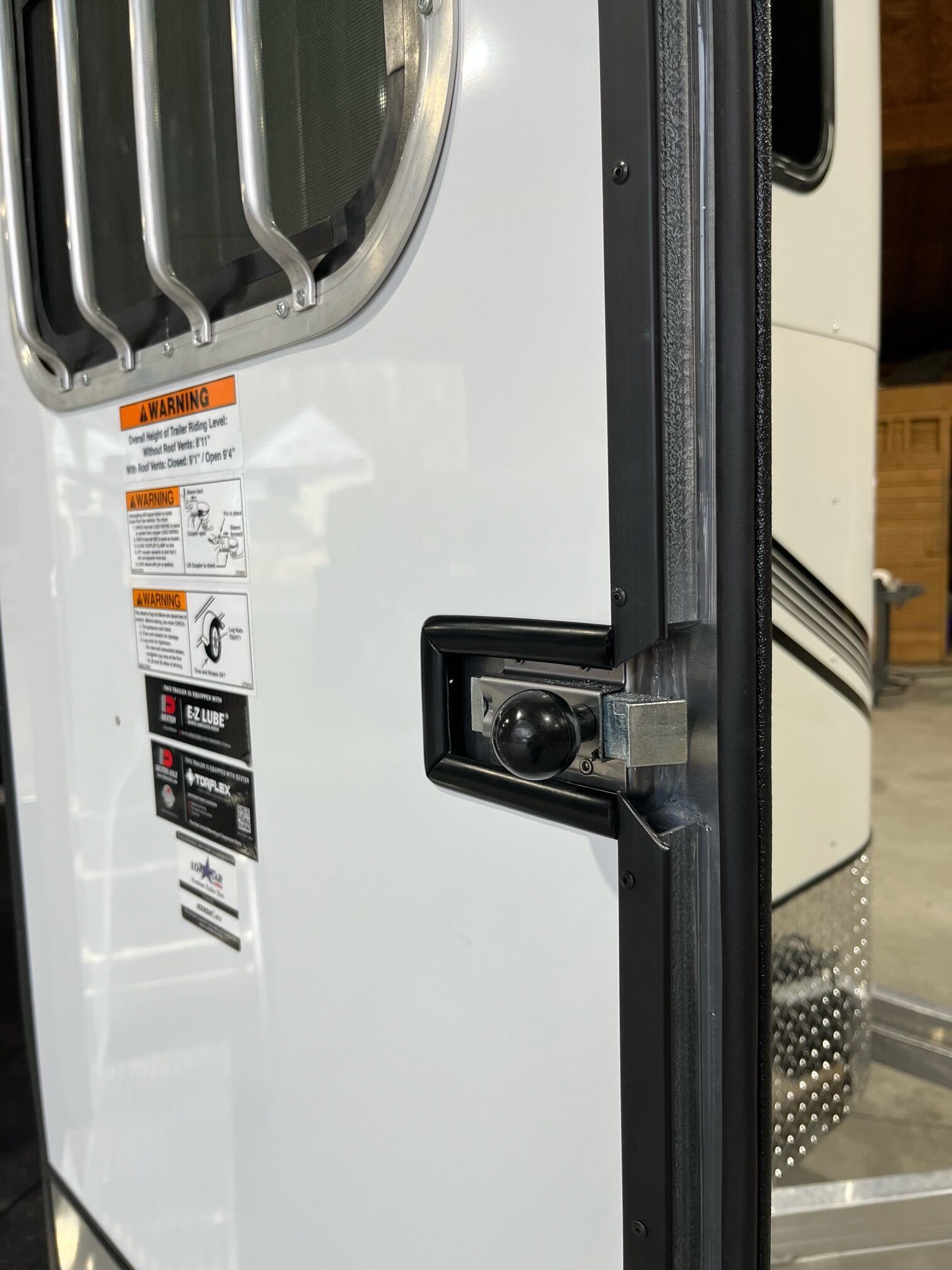 A close up of a door on a trailer with a window.