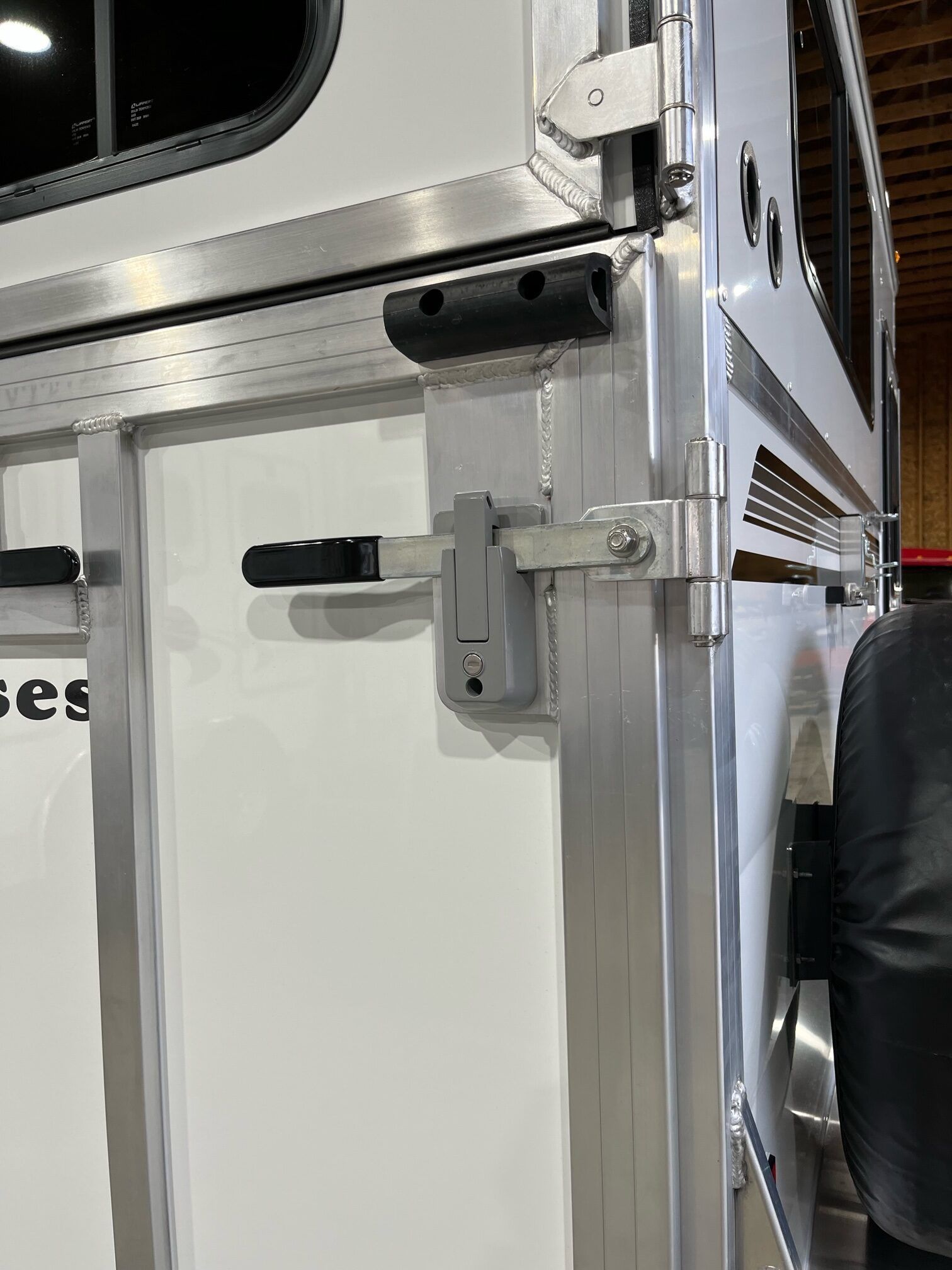 A close up of a door lock on a horse trailer.