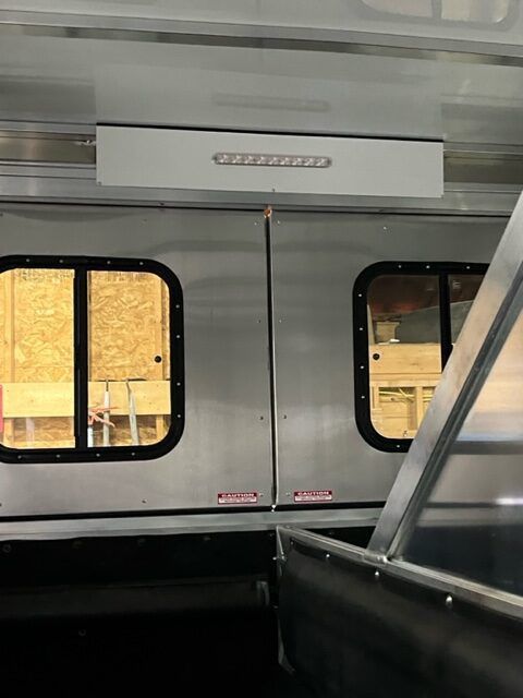 A stainless steel door with a light on top of it