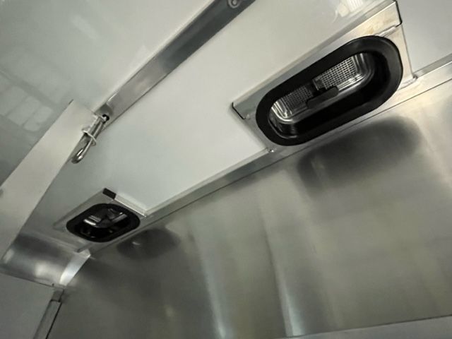 A close up of a stainless steel wall with two lights on it.