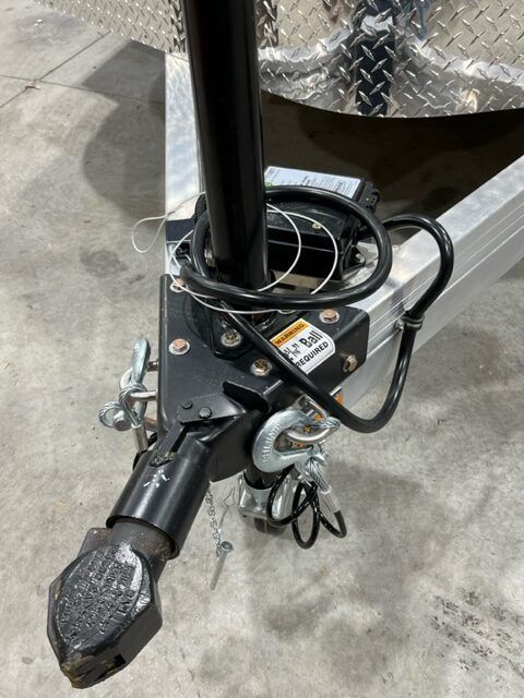 A close up of a trailer hitch on a concrete surface