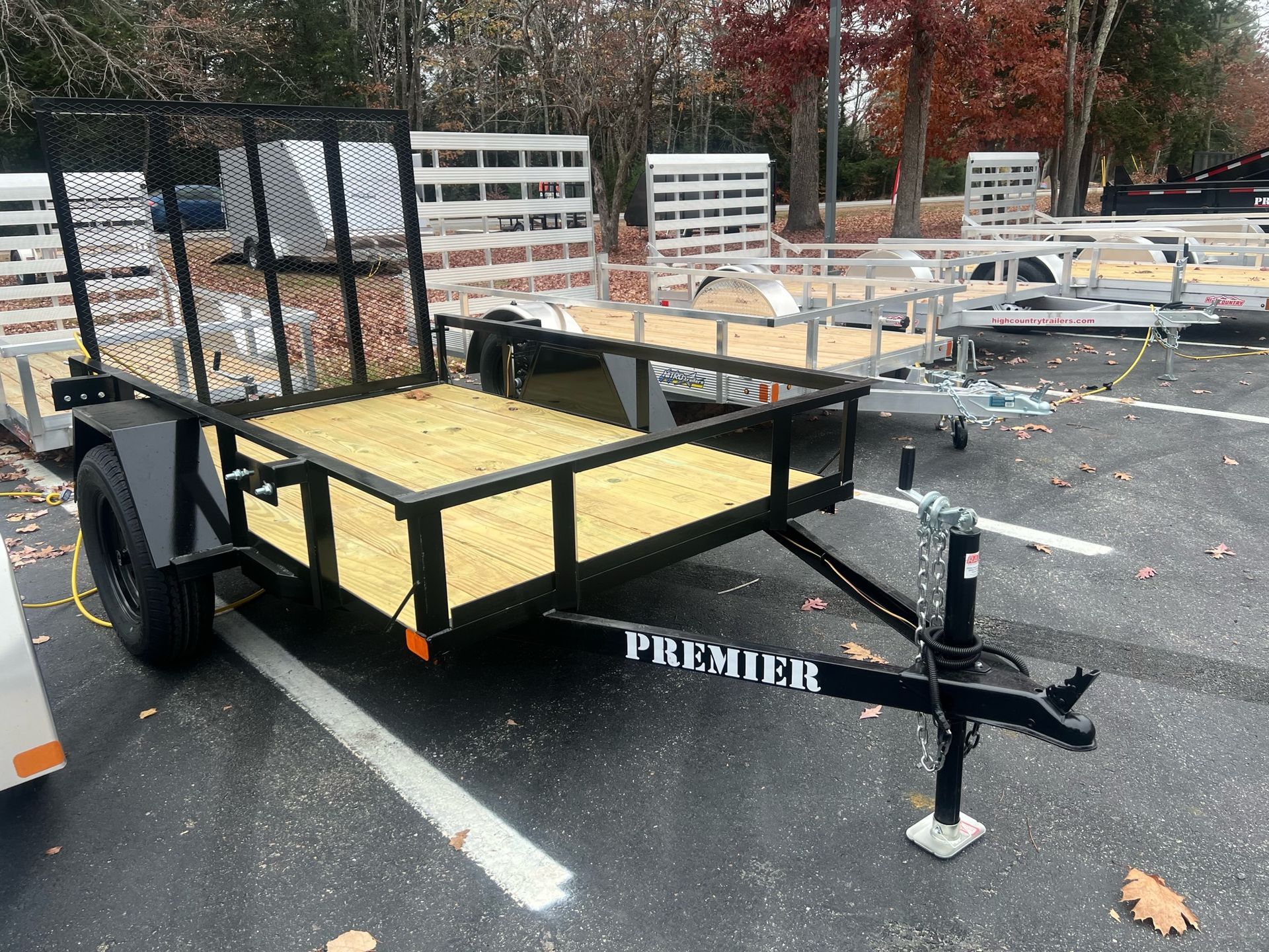 A small trailer is parked in a parking lot