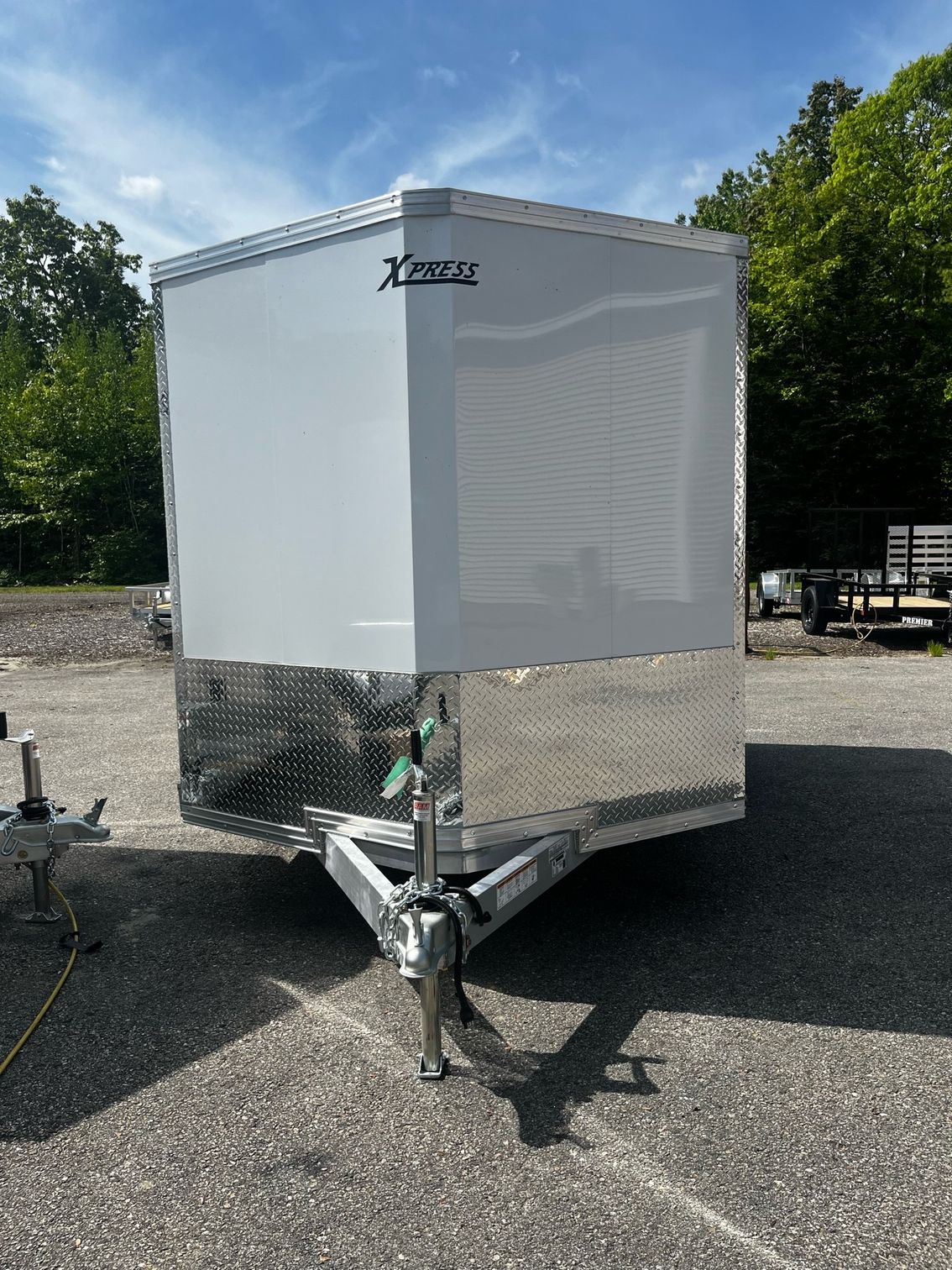 A white trailer is parked in a parking lot.