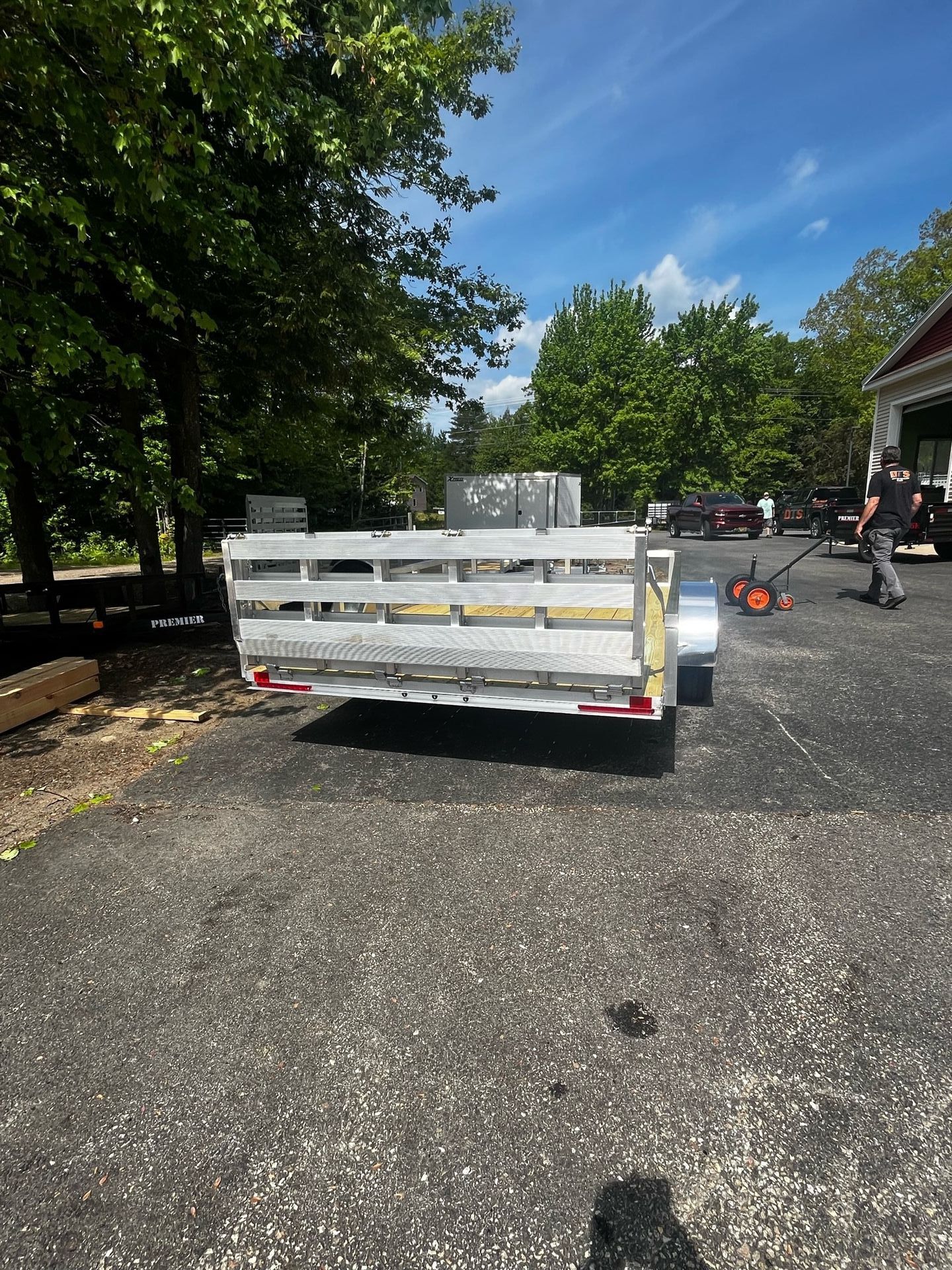 A white trailer is parked on the side of the road