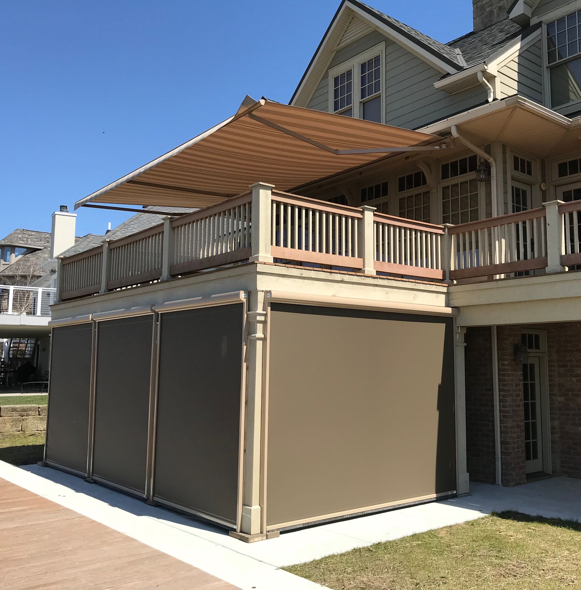 A house with a large deck and a large awning over it