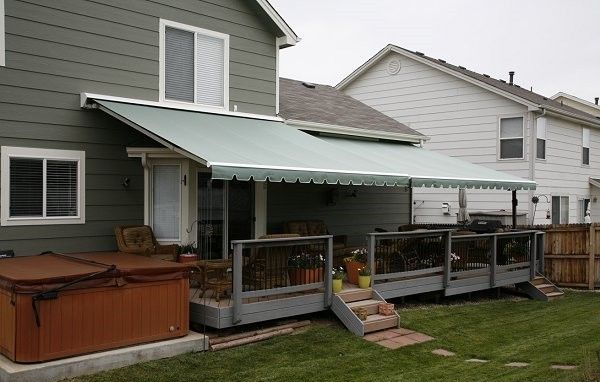 A house with a green awning on the back porch