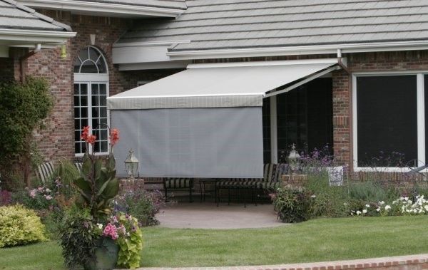 A house with a white awning on the side of it