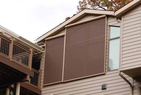 A house with windows covered by solar screens