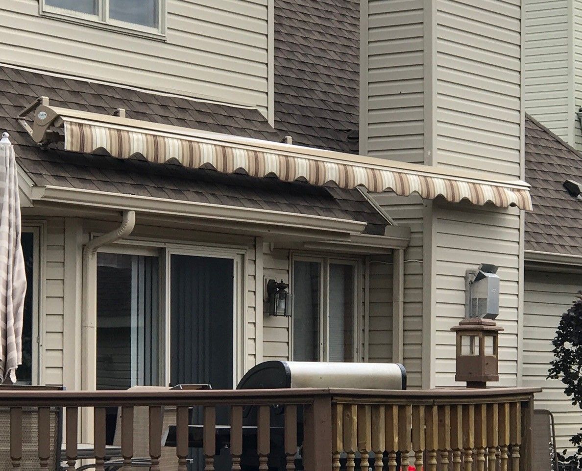 A house with a striped awning on the roof