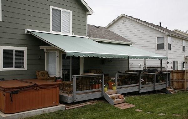 A house with a green awning on the back porch