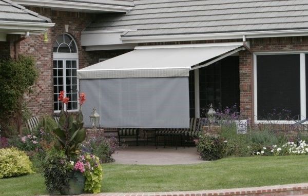 A house with a white awning on the side of it