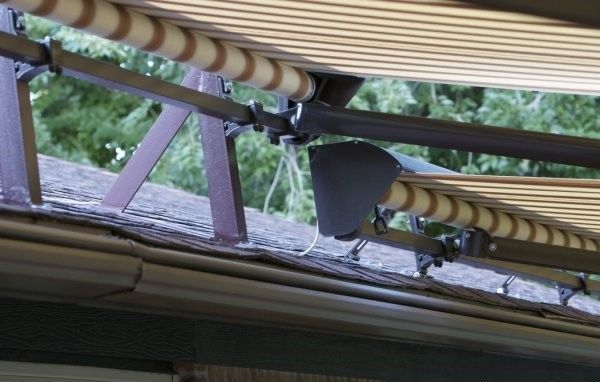 A striped awning is on the roof of a building