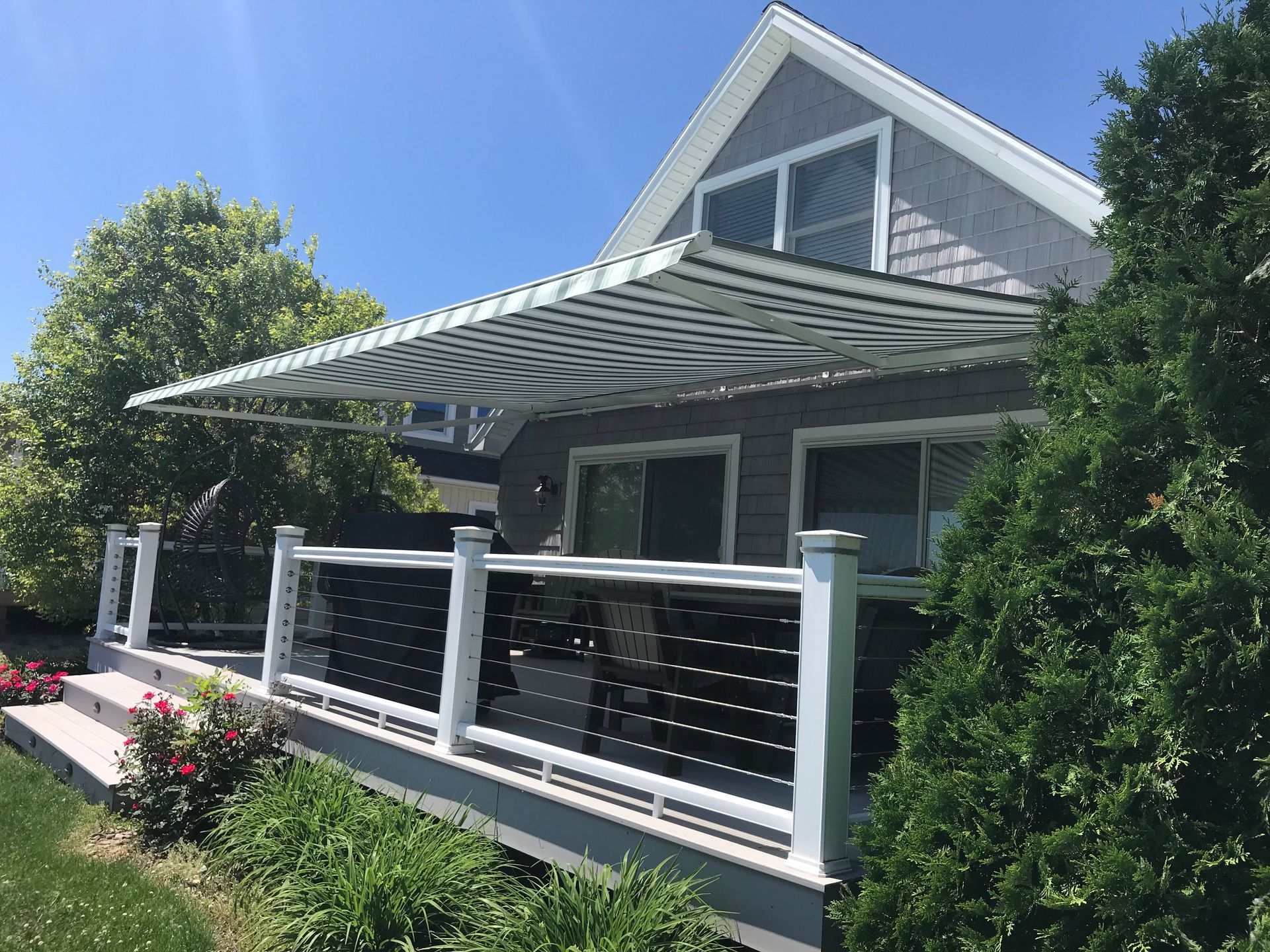 A house with a porch and awning on it.