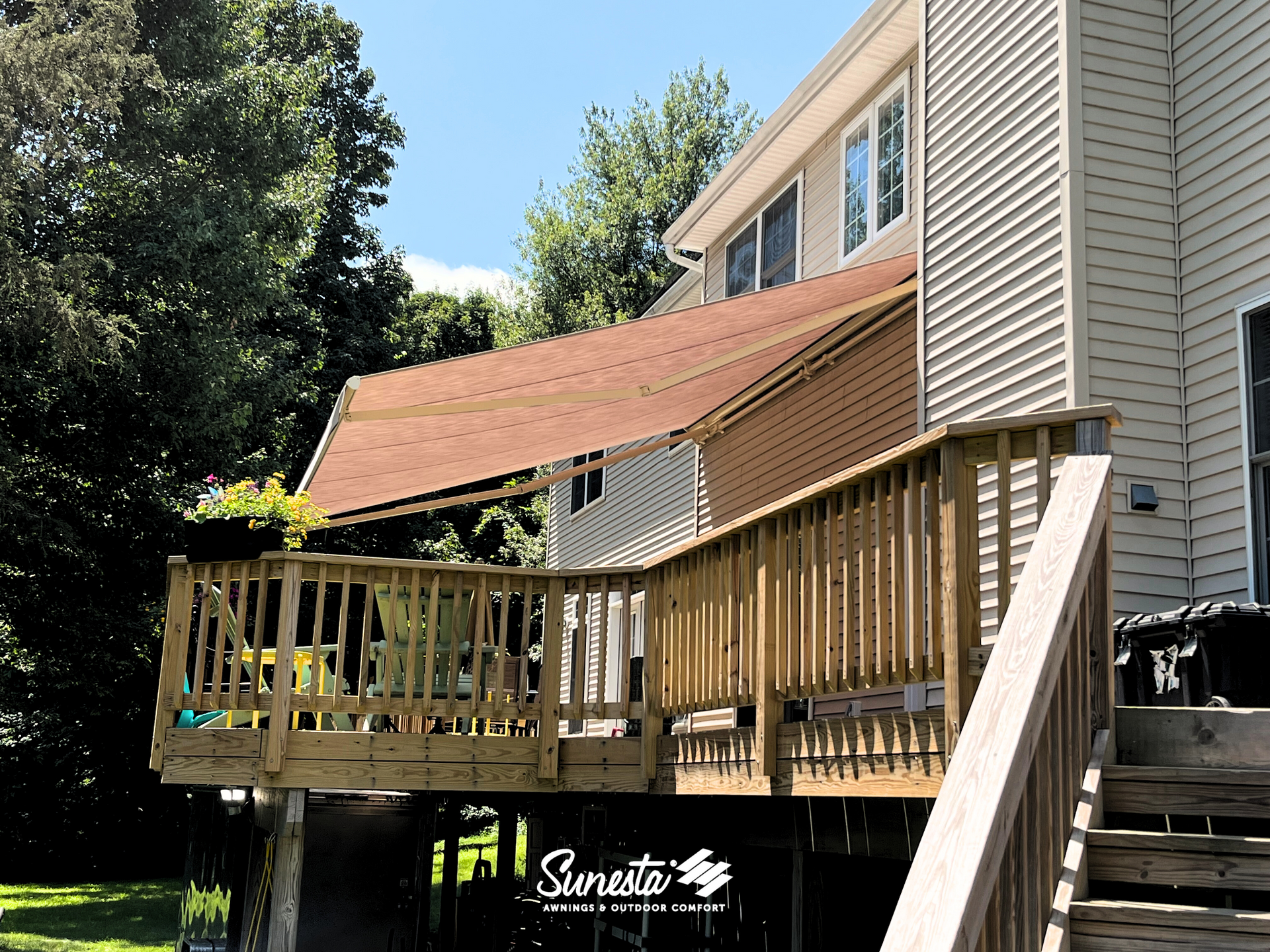 A wooden deck with a canopy over it and stairs leading up to it.