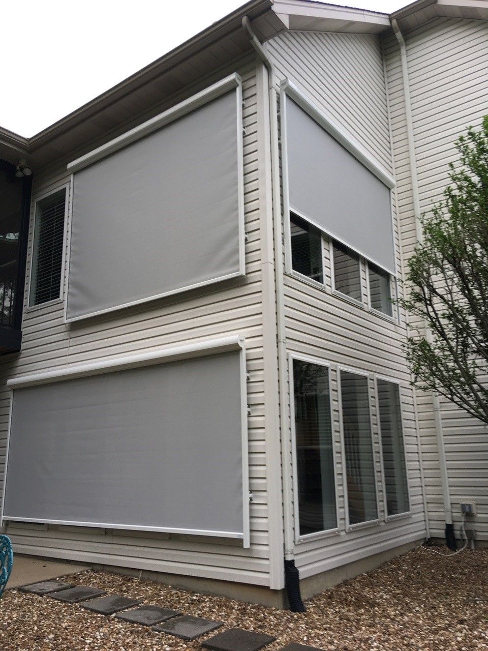 A house featuring numerous windows equipped with solar screens