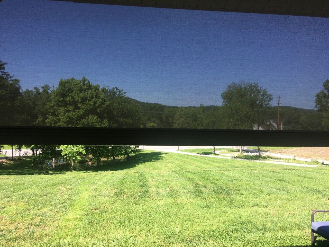 A window with its upper half fitted with a solar screen