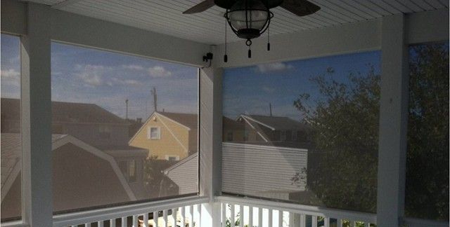 A solar screened porch with a ceiling fan