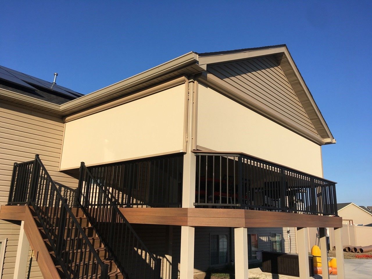 A large house deck covered with solar screens