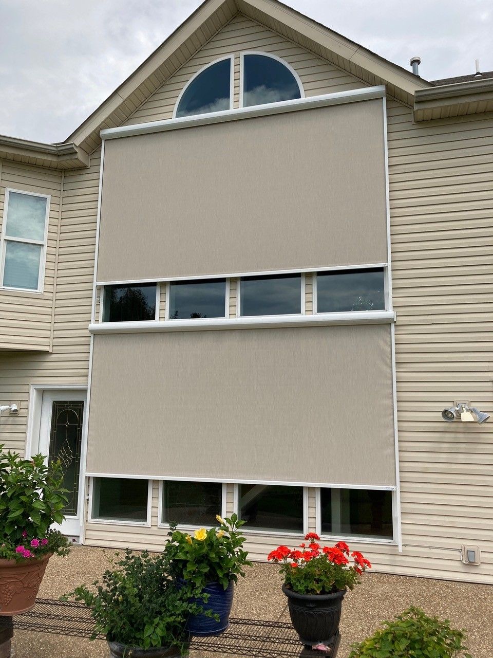A house featuring numerous windows equipped with solar screens