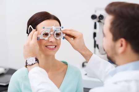 A woman is getting her eyes checked by an ophthalmologist.