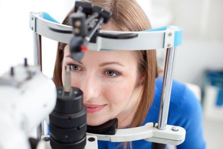 A woman is getting her eyes examined by an ophthalmologist.