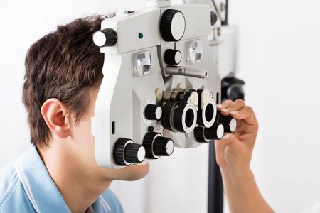 A man is getting his eyes examined by an ophthalmologist.