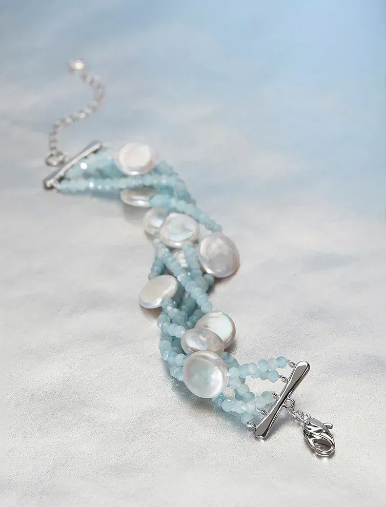Blue beaded bracelet with white pearl accents.
