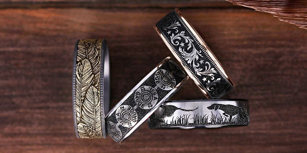 Engraved rings with various detailed designs on a wooden surface.