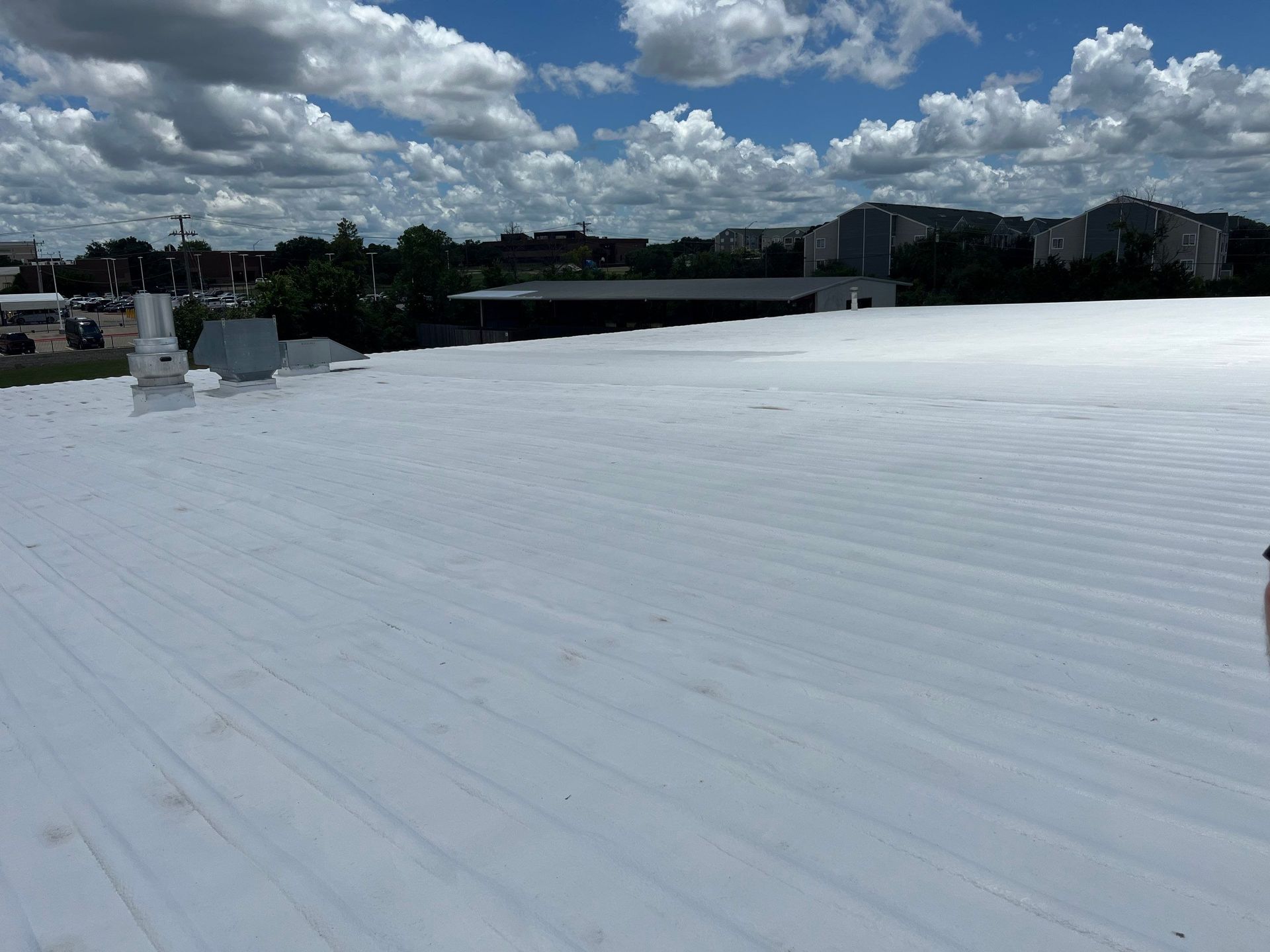 A large white roof with a blue sky in the background