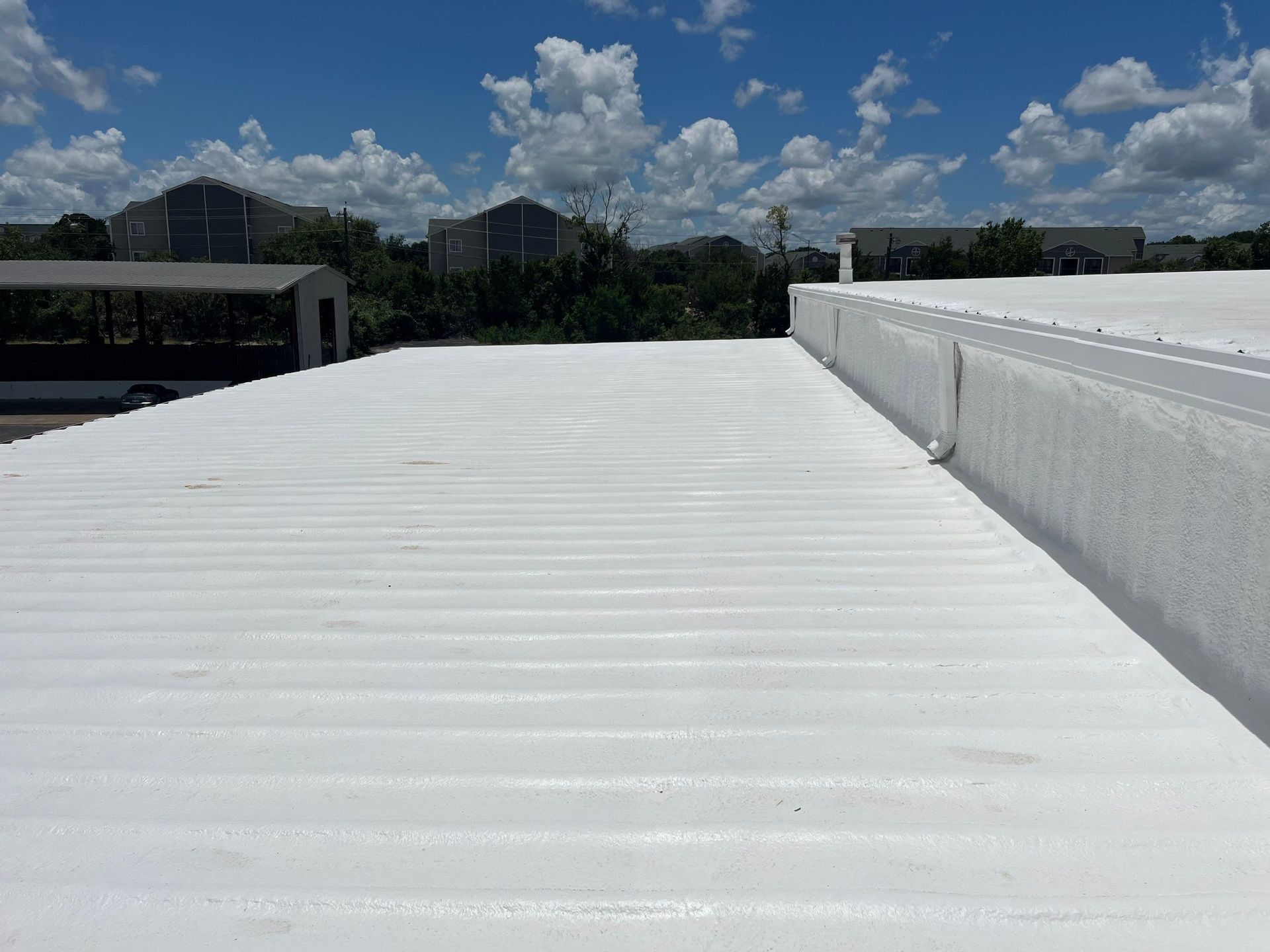 A white roof with a blue sky in the background.