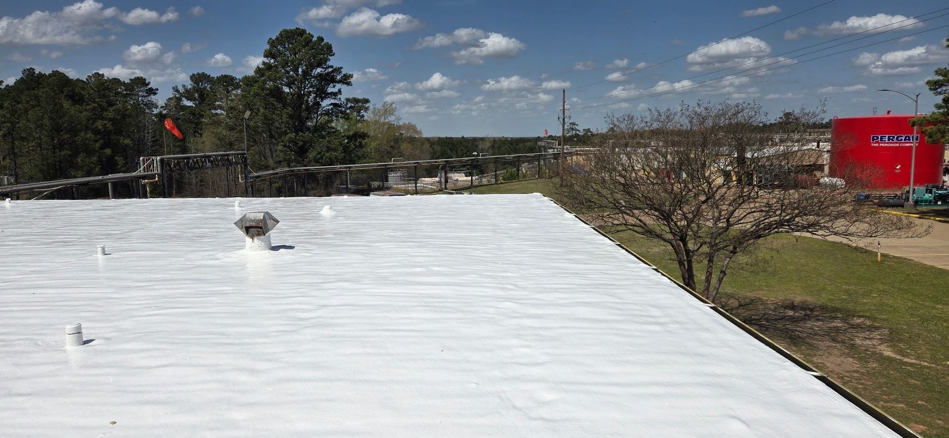 A white roof with a chimney on top of it.