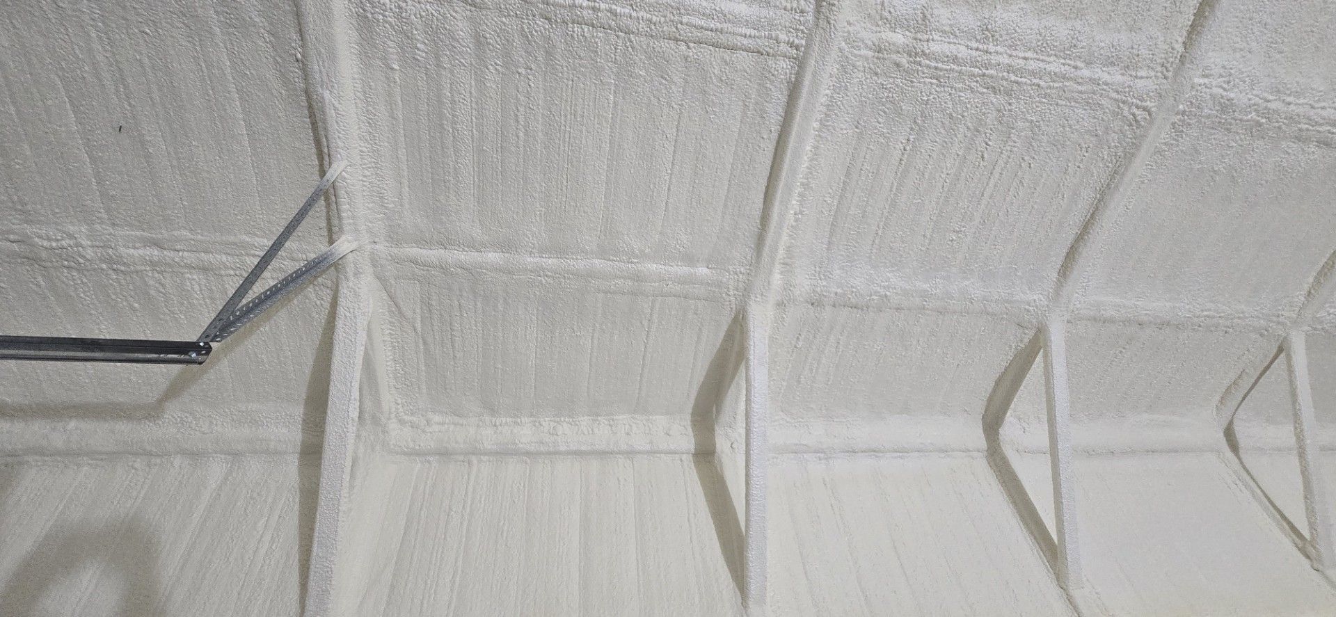 A close up of a white ceiling in a room.