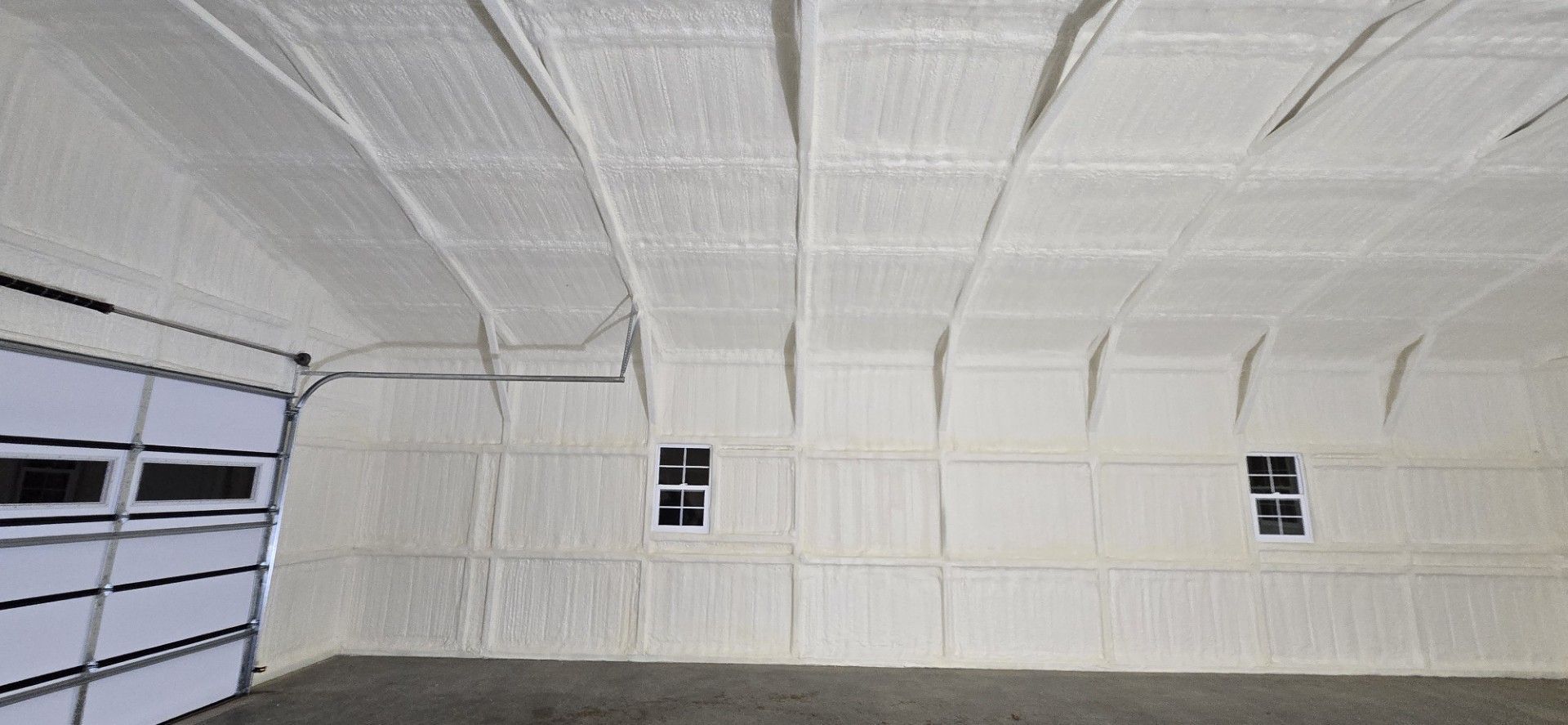 The ceiling of a garage is covered in white foam.