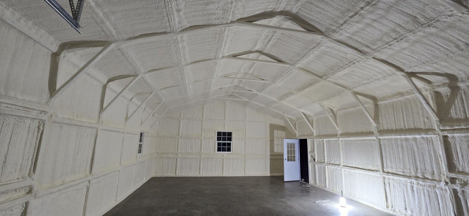 The ceiling of a garage is covered in white foam.