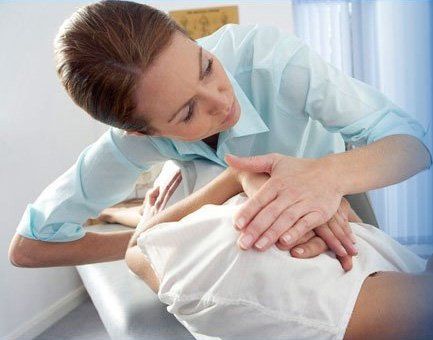 chiropractor massaging patient