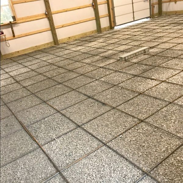 Concrete floor with rebar grid in a garage setting.