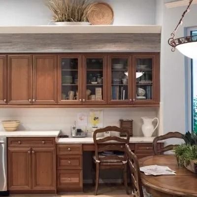Kitchen with wood cabinets, countertop, and a built-in desk area.