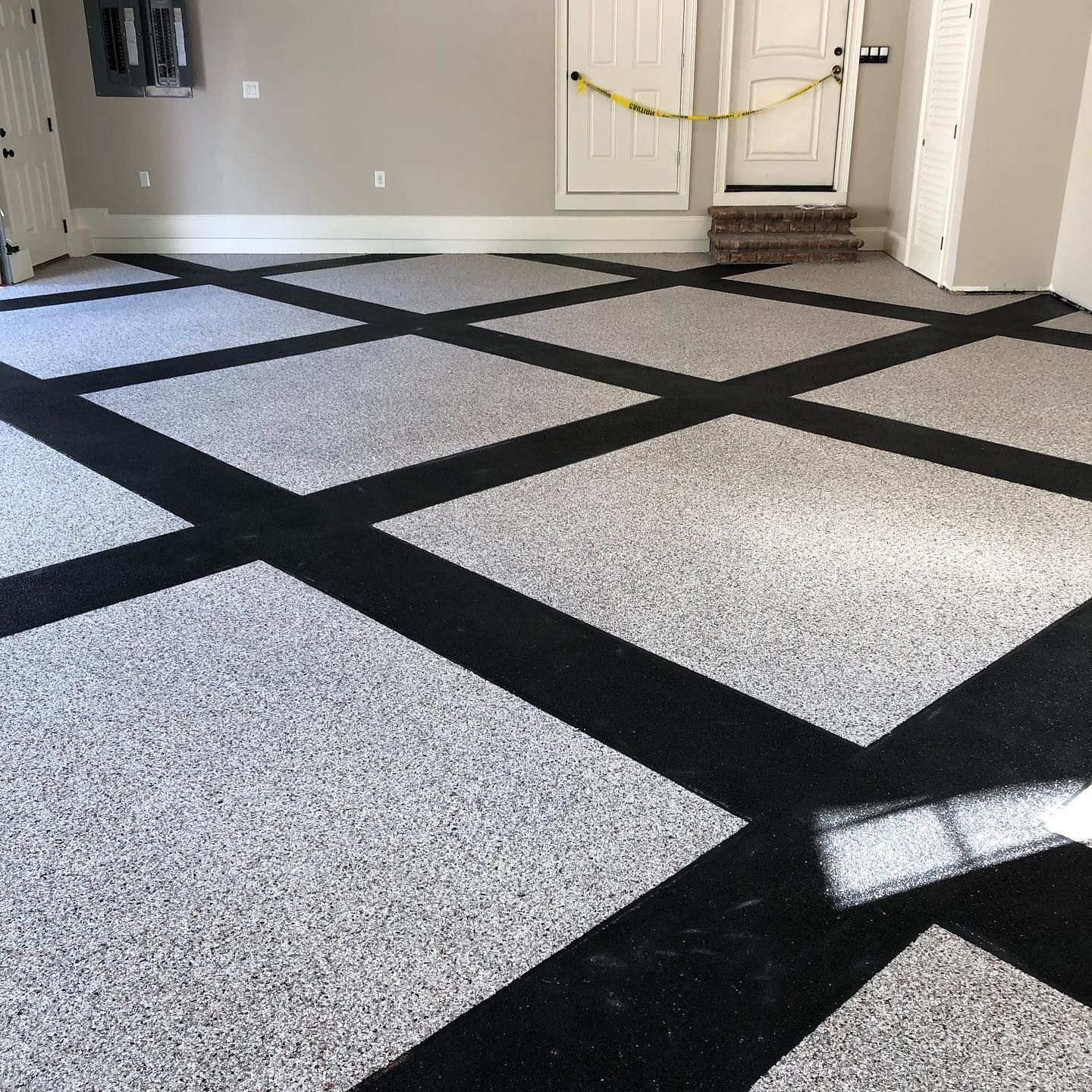 A garage floor with a black and white checkered pattern.