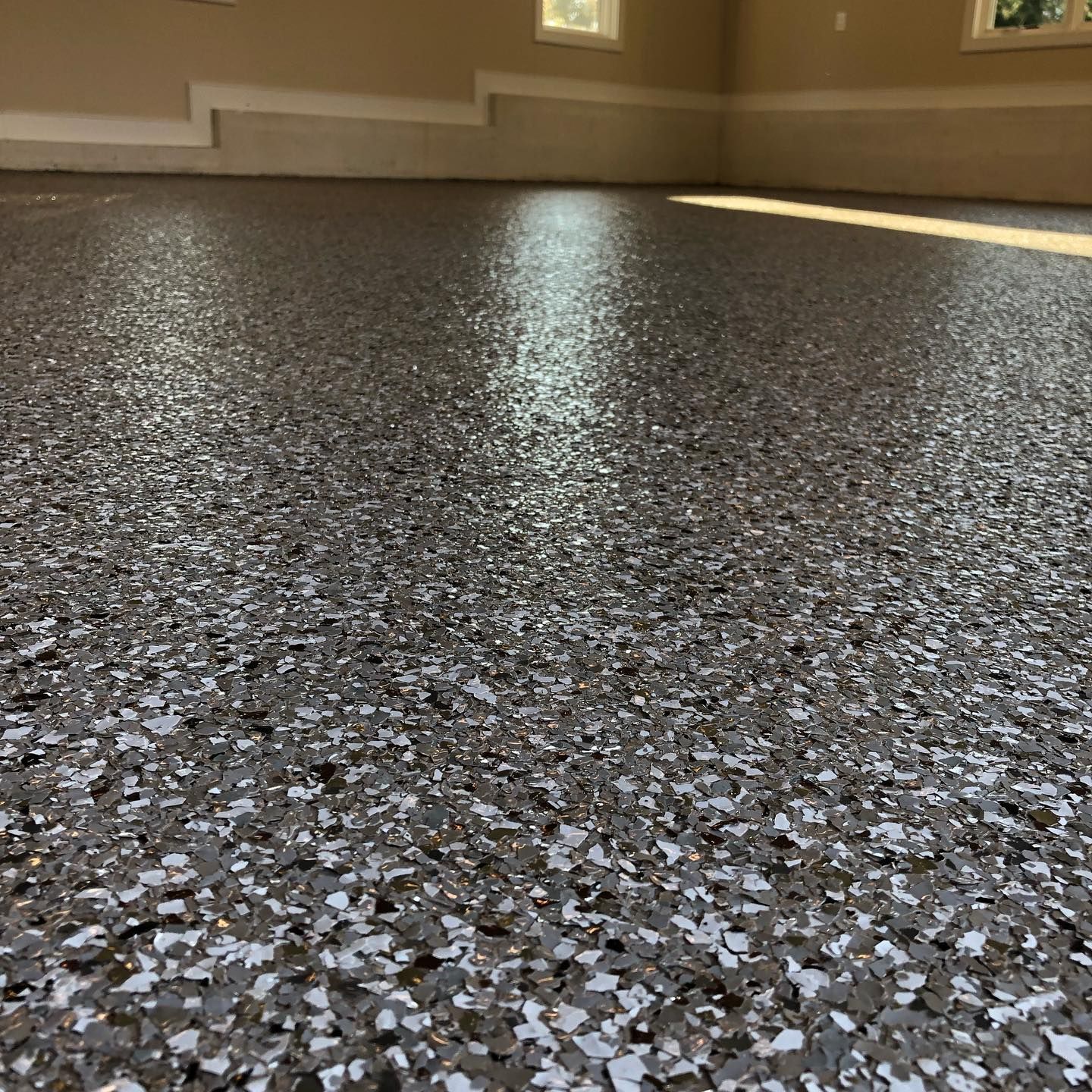 A close up of a garage floor with a lot of small rocks on it.