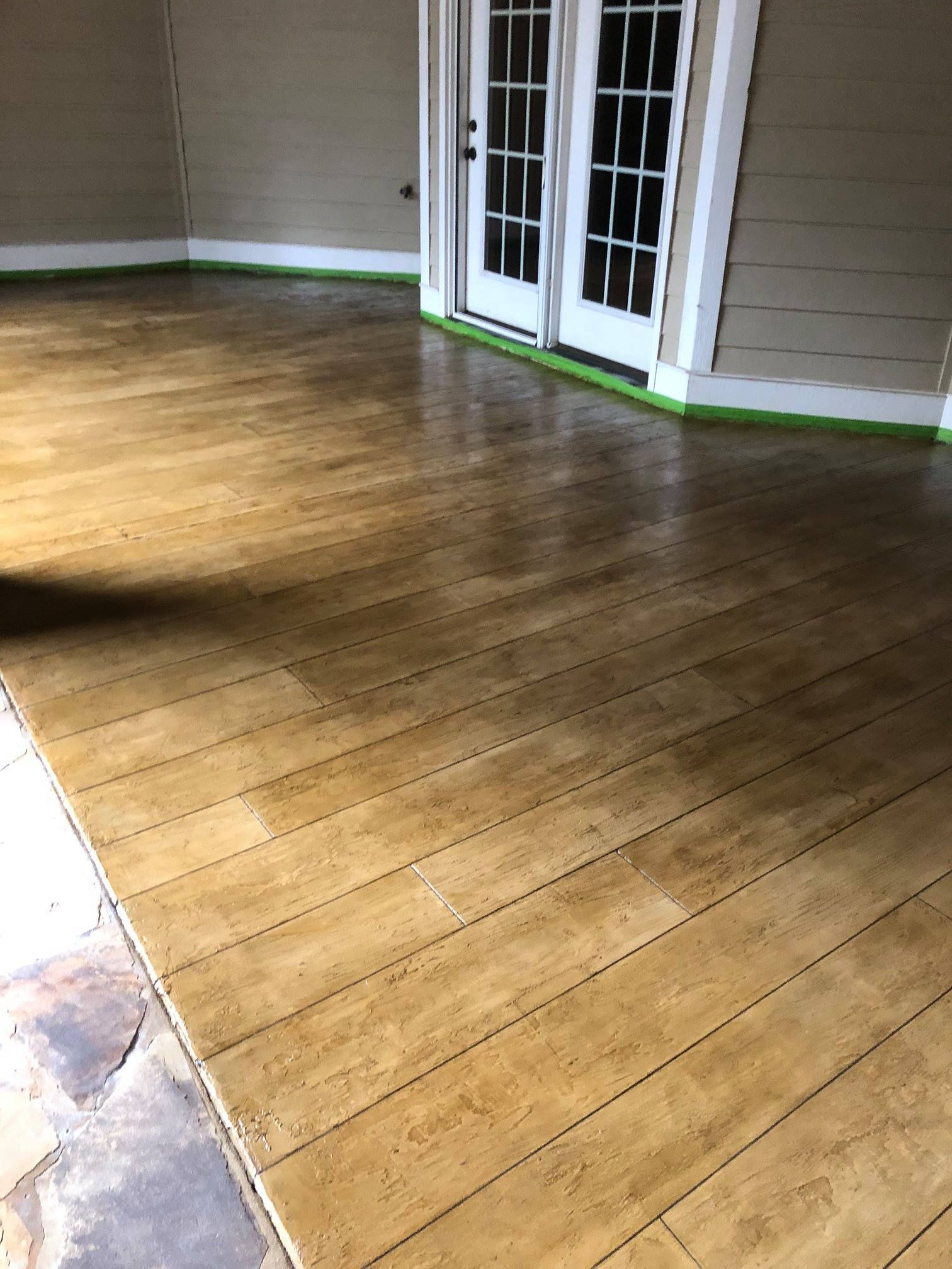 A room with a wooden floor and french doors.