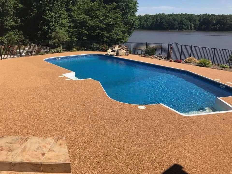 A large swimming pool with a view of a lake