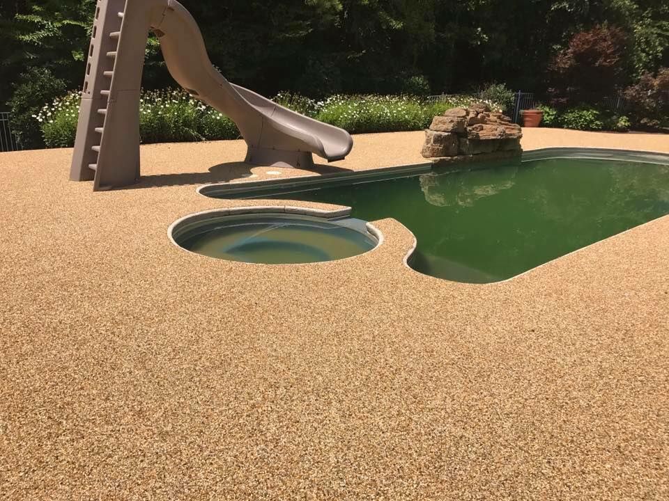 A swimming pool with a slide and a hot tub