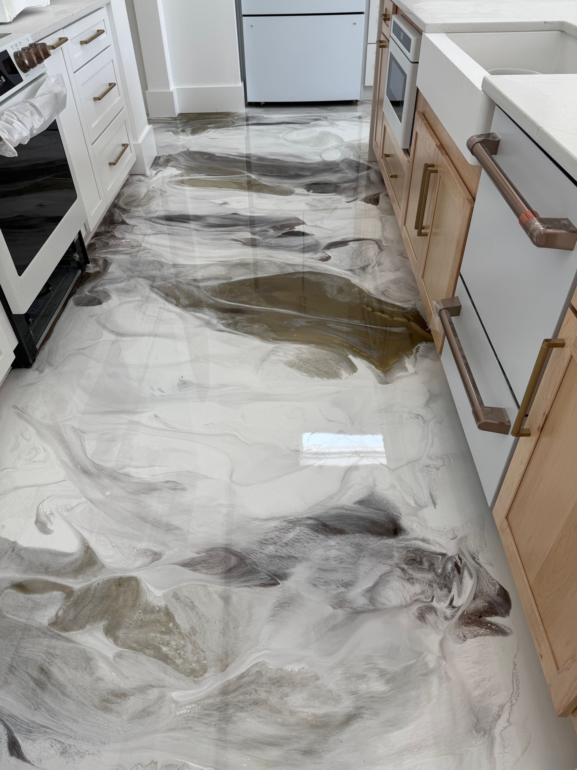 A kitchen with a marble floor and a sink.