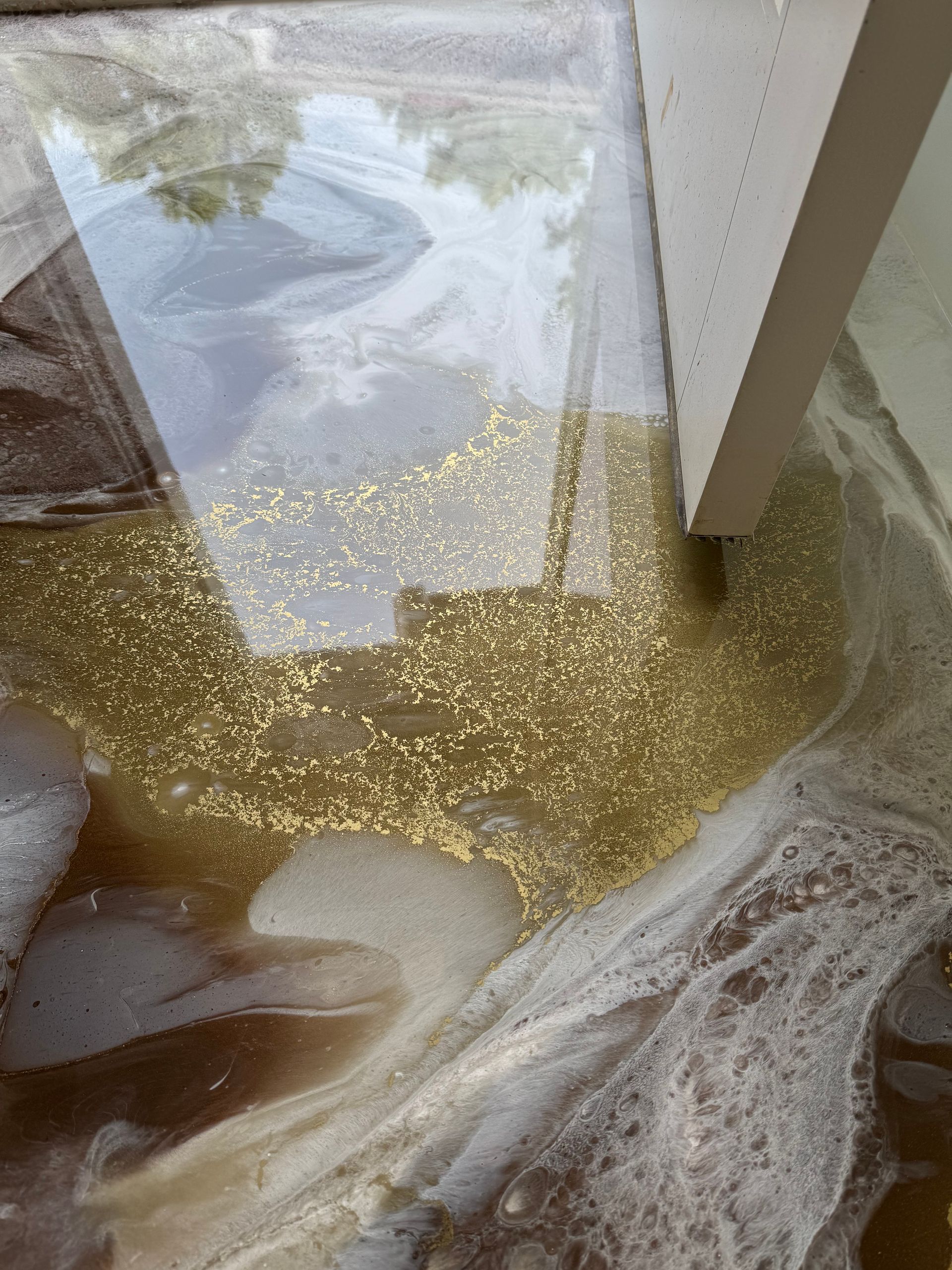 A close up of a glass table with gold glitter on it.