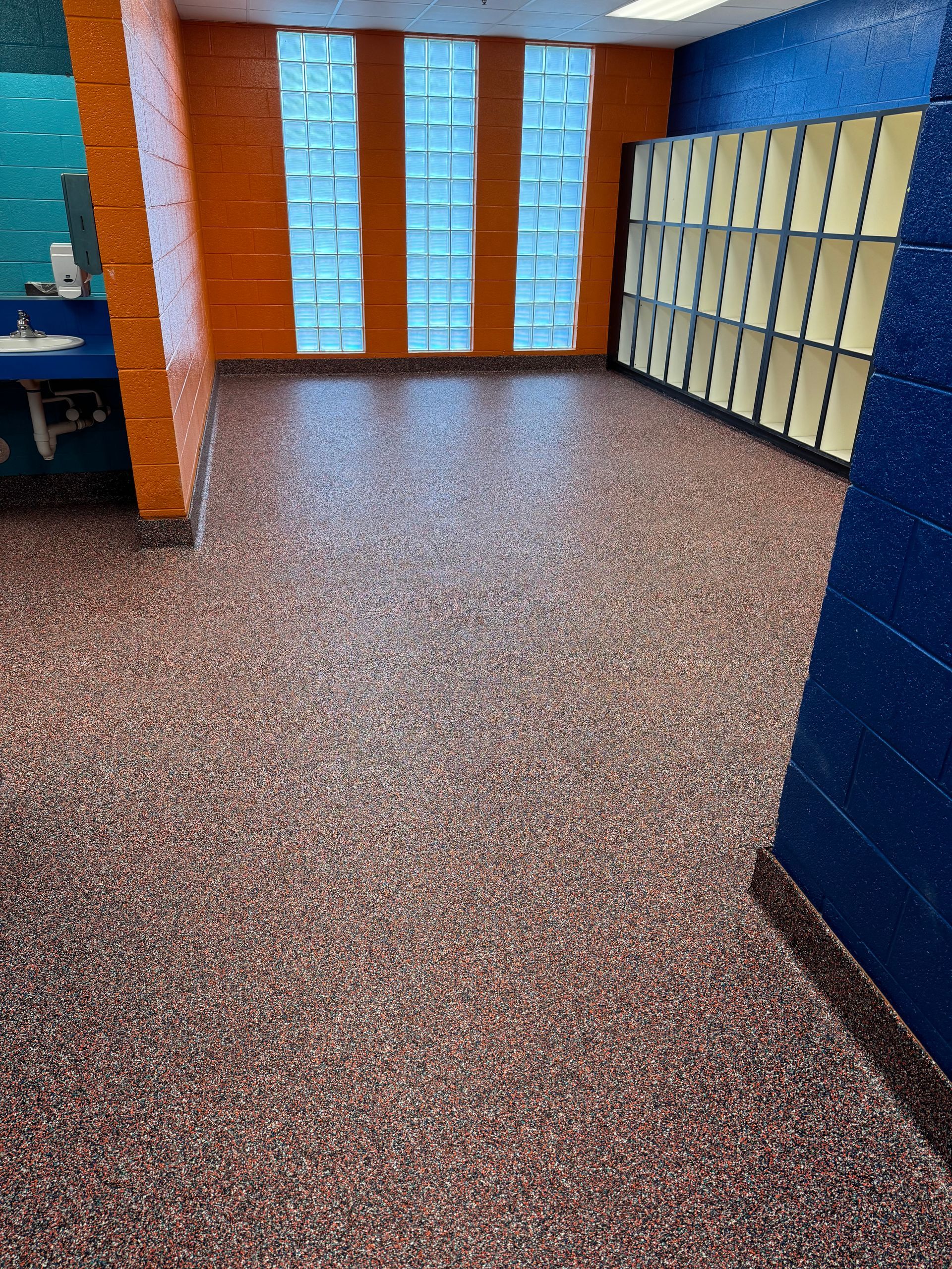 A room with a carpeted floor and lockers in it.