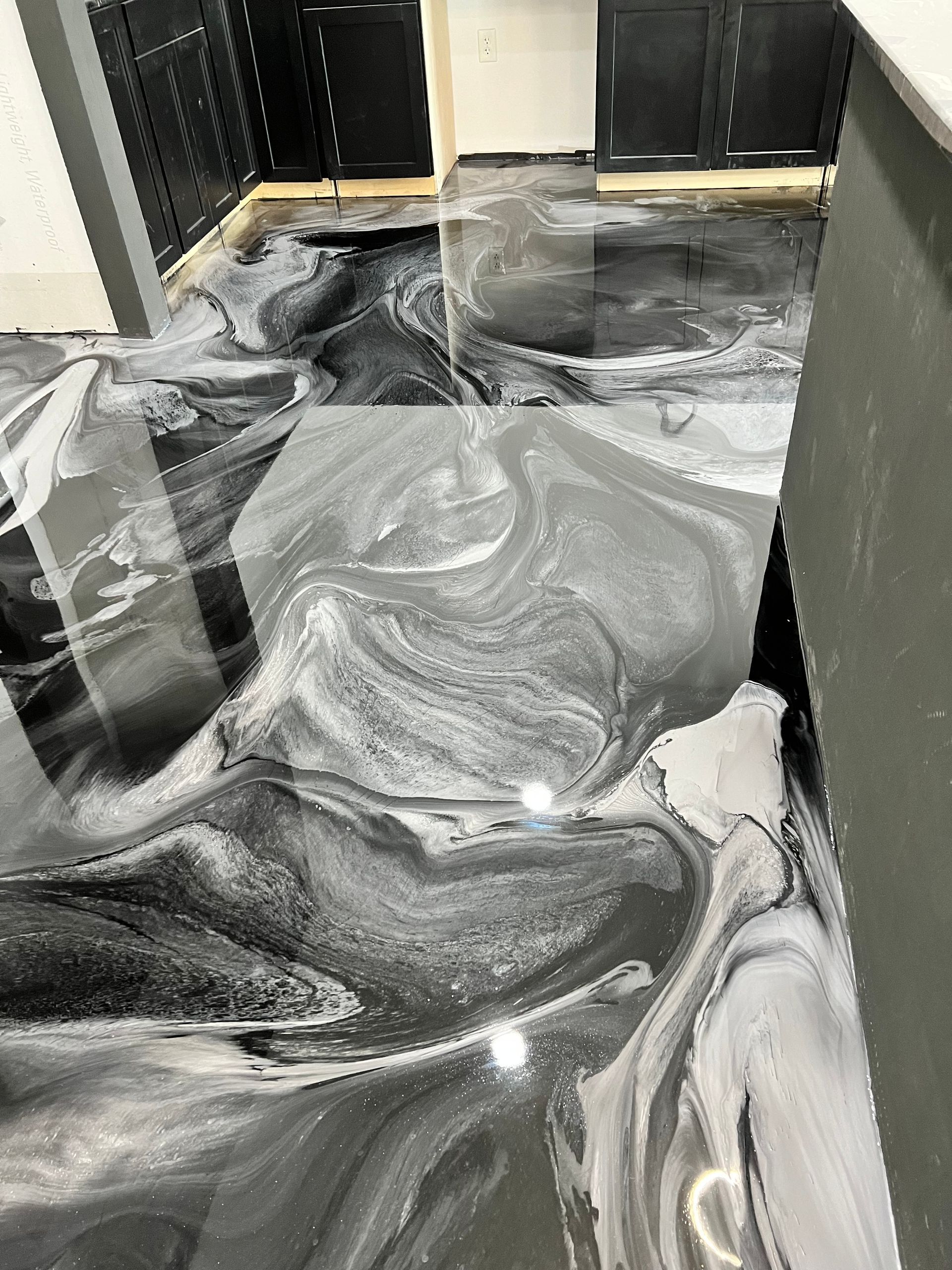 A black and white marble floor in a kitchen.