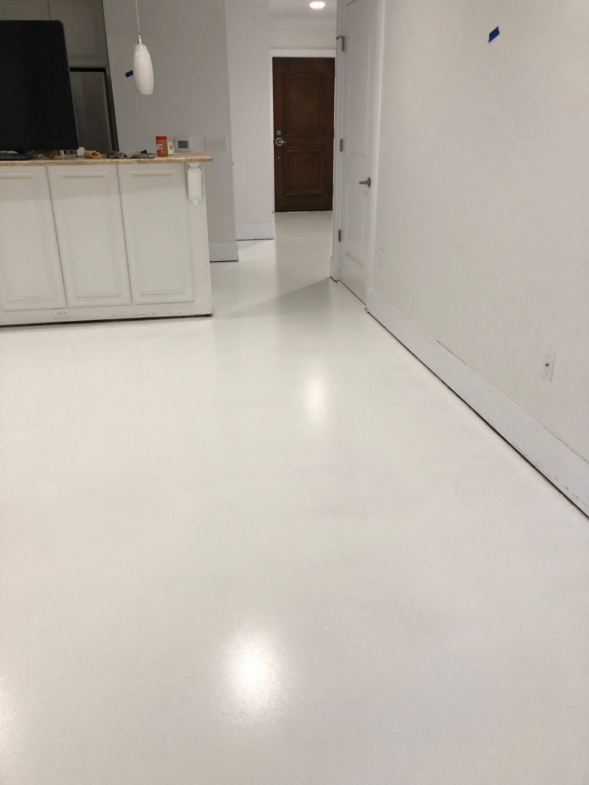 A room with a white floor and white walls.